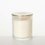 White candle in a clear glass jar with a gold lid