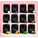 Set of black scented candles on white risers with small floral accents