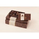 Stacked boxes of assorted chocolates with one open tray