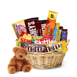 Basket of assorted candy bars with a small teddy bear