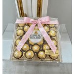 Box of Ferrero Rocher chocolates tied with a pink ribbon