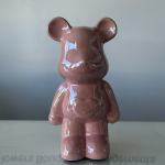 Pink ceramic bear figurine with a glossy finish