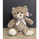 Plush teddy bear with a pink ribbon and tag