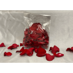 Bag of red rose petals with loose petals scattered around