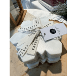 Stacked white foam ornaments tied with branded ribbon and a tag