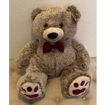 Large plush teddy bear with a red bow tie