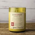 Yellow candle in a glass jar with a printed label
