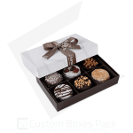 Box of assorted decorated chocolates with a ribbon-tied lid