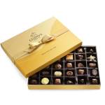 Gold gift box of assorted chocolates with a ribbon