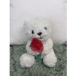 White plush teddy bear holding a red fabric rose