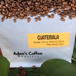 Bag of Guatemala coffee beans with a label and green leaves
