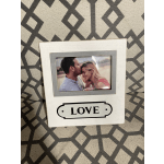 White photo frame with a couple's picture and the word LOVE