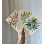 Hand holding three floral greeting cards with watercolor flowers