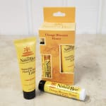 Orange Blossom Honey lotion, lip balm, and gift box on a countertop