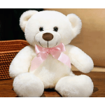 White teddy bear with a pink ribbon sitting on a wooden surface