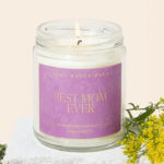 Glass jar candle with a purple label reading "Best Mom Ever"