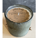Green textured candle in a glass container with a labeled top