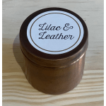 Brown jar with a lid labeled "Lilac & Leather"