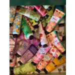 Assorted hand cream tubes with floral and fruit designs in a box