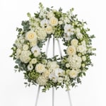 White floral wreath on a standing easel