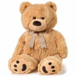Plush teddy bear with a ribbon bow on a white background