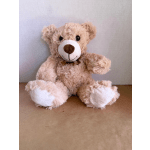Plush teddy bear with a brown ribbon sitting against a plain background