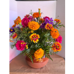 Bright mixed bouquet with pink roses and orange marigolds in a vase