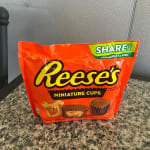 A bag of Reese's Miniature Cups on a countertop.