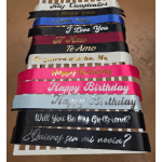 Stack of decorative satin ribbons with birthday and love messages