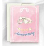 Pink anniversary card with two rings and a cream envelope behind it