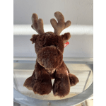 Brown plush moose with antlers sitting on a glass surface