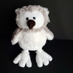 Plush owl toy with white face and fluffy gray body