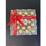 Box of Ferrero Rocher chocolates tied with a red ribbon