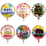 Six round birthday balloons with colorful printed designs and messages.