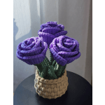 Three purple roses in a woven basket