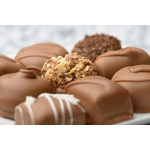 Assorted chocolate truffles and nut-covered chocolates on a plate