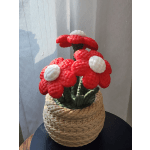 Red and white mushroom-shaped floral sculpture in a woven basket