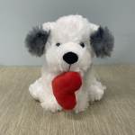 White plush dog holding a red heart