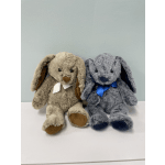 Two plush bunny toys with ribbon bows sit side by side.