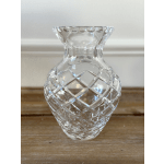 Clear cut-glass vase on a wooden surface