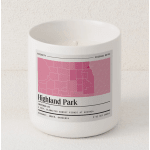 White candle in a glass jar with a pink label