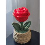 Red rose-shaped decorative piece in a woven basket planter