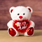 White teddy bear holding a red heart with "Te Amo" text