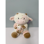 Plush cow toy holding a smaller cow plush