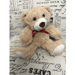Plush teddy bear with a red ribbon bow