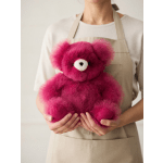 Person holding a bright pink teddy bear