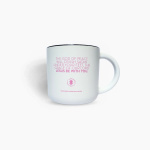 White mug with pink religious text and a black rim