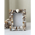 Decorative photo frame covered in shell pieces
