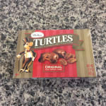 Box of Turtles caramel nut clusters on a countertop