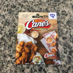 Raising Cane's $15 gift card on a granite countertop